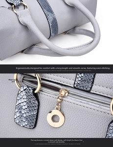 Detail of grey-blue lychee leather handbag featuring snake-print trim and gold hardware