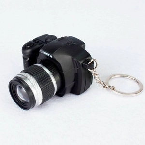 Mini SLR camera keychain in black and silver with LED light and sound effect