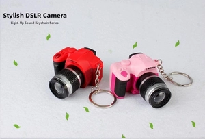 Mini SLR camera keychains in red and pink featuring LED lights and shutter sound effects