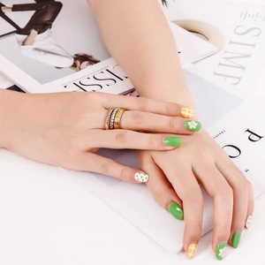 Three-tone stainless steel stacked rings in gold, silver and rose gold on model hand