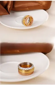 Detailed view of tricolor stacked rings featuring classic Parisian clou de paris texture