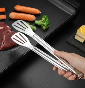 Nahaufnahme der Edelstahl-Lebensmittelzange mit hohlem Schaufelkopf zum Grillen und Braten