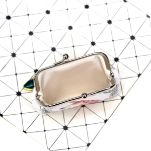 Detail view of open floral canvas coin purse with vintage silver metal clasp closure