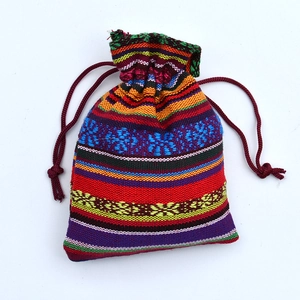 Close-up of ethnic style woven cotton drawstring bag with colorful bohemian patterns