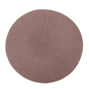 Detailed top view of a dark red wool knit beret showing fine texture and simple design