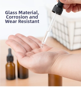 Macro shot of essential oil amber glass dropper bottle applying liquid to palm