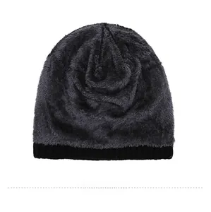Close-up detail of the thick dark grey fleece lining inside the black knitted winter beanie
