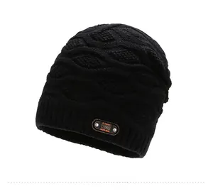 Detail of black knit beanie featuring textured honeycomb pattern and leather classic label