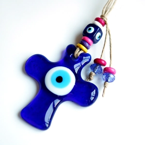 Blue glass cross ornament with evil eye and colorful wooden beads on a hemp rope