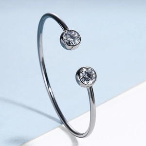 Elegant minimalist silver open cuff bangle featuring two sparkling round cubic zirconia
