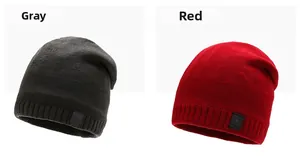 Detailed close-up of grey and red knitted winter hats with ribbed cuffs and star patches