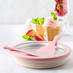 Pink rolled ice cream maker pan with two scrapers and fresh strawberry garnish