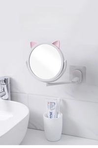 Detail of adjustable swivel bathroom mirror with cute cat ears and extendable folding arm