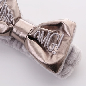 Cute grey plush headband with bronze PU bow and OMG! embroidery for makeup