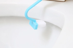 Detail view of V-shaped toilet brush head cleaning deep under the toilet rim and grooves