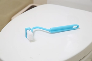 Blue V-shape toilet brush with curved long handle for deep rim and corner cleaning
