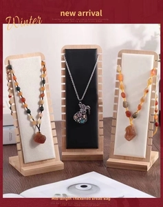 Bamboo jewelry stand showing ethnic beaded necklaces and silver pendant with gemstones