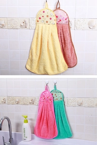 Hanging coral fleece towels in yellow, pink and green shown in a kitchen setting