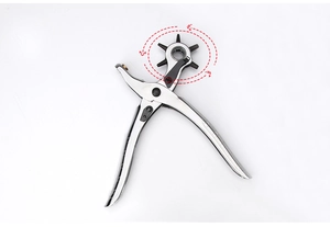 Detail of silver metal leather hole punch tool with rotating black turret and six hole sizes