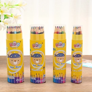 Detail view of four barrels containing sets of colored drawing pencils on a wooden surface