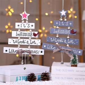 Hanging wooden Christmas tree decoration with bells and festive bow in white and blue
