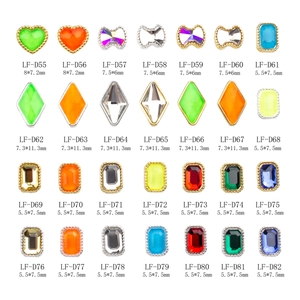 Assorted colorful gemstone nail charms with metal edging in various geometric shapes