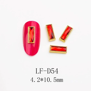 Close-up of red rectangular nail rhinestones with gold metal borders in 4.2x10.5mm size