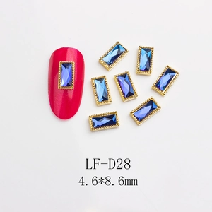 Detail of blue rectangular nail gems with gold beaded edges and size 4.6x8.6mm