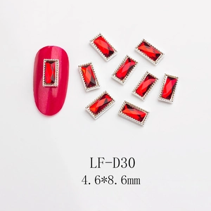 Macro detail of 4.6x8.6mm dark red rectangular nail art rhinestones with silver metal edges