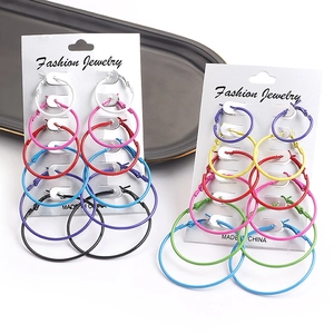 Set of six pairs of colorful hoop earrings in various sizes on white display cards