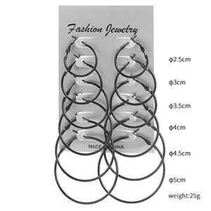 Set of 6 black hoop earrings in sizes 2.5cm to 5.0cm displayed on a fashion card