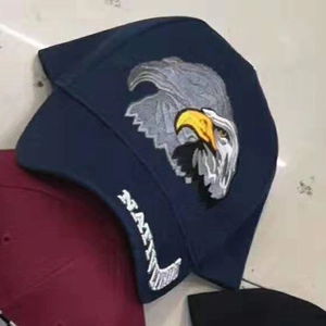 Detailed embroidery of eagle head and NAVY text on a navy blue baseball cap