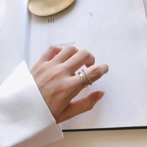 Minimalist silver rings on hand featuring a smooth band and fine beaded chain design