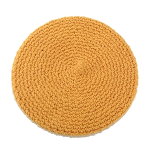 Hand-crocheted mustard yellow beret hat with thick knit texture and spiral pattern