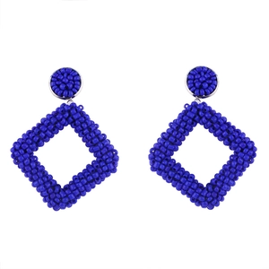 Detail of dark blue beaded earrings featuring handcrafted geometric rhombus charms