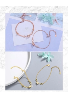 Close-up of S925 sterling silver cylinder charms on rose gold and gold dainty chains