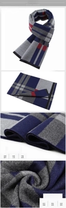 Close-up detail of navy blue plaid scarf with thick fringe and precise stitching