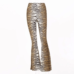 Detailed view of high waisted flared pants featuring a bold tiger stripe pattern print