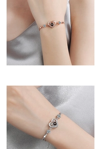 Macro shot of rose gold and silver heart bracelets featuring a black projection stone