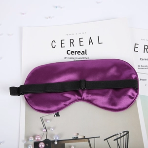 Detail of purple satin sleep mask with adjustable elastic strap and smooth texture
