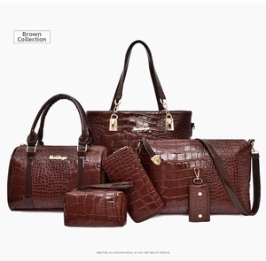 Detail view of 6-piece brown tote bag set with crocodile pattern and gold hardware