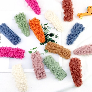 Close-up of geometric hair clips set in colorful soft teddy velvet and plush textures