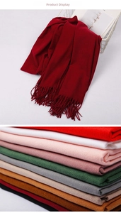 Close-up of multicolored cashmere-feel scarves with long fringes and stack of color options