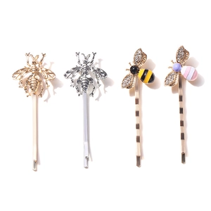 Set of four colorful bee hair pins with sparkling crystals and vibrant enamel details