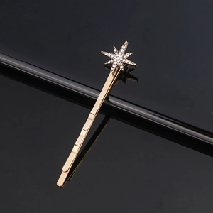Elegant gold octagram star hair clip with crystals on a sleek black background
