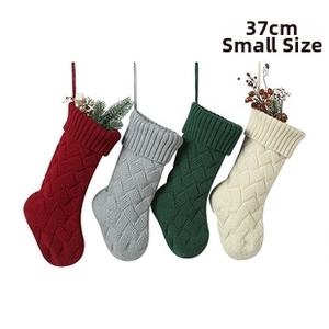 Detail view of 37CM small knitted Christmas stockings with classic cable stitch texture