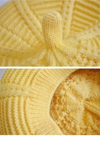 Close-up of yellow knitted beret showing soft wool texture and top stem detail