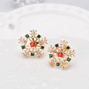 Detailed view of snowflake earrings with red, green and white rhinestones in gold finish