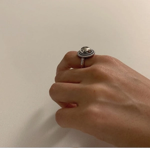 Close-up of a minimalist vintage 925 silver mirror ring worn on a finger