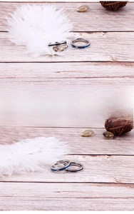 Detail of titanium steel rings with blue and black inlay lines on wooden background